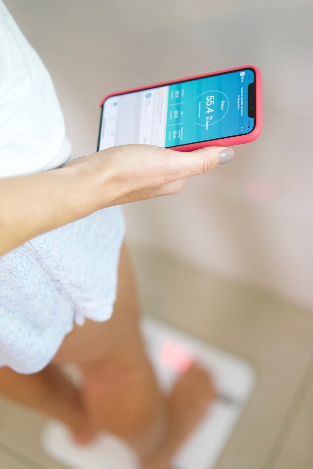 Hand holding a phone showing the Mantra app
