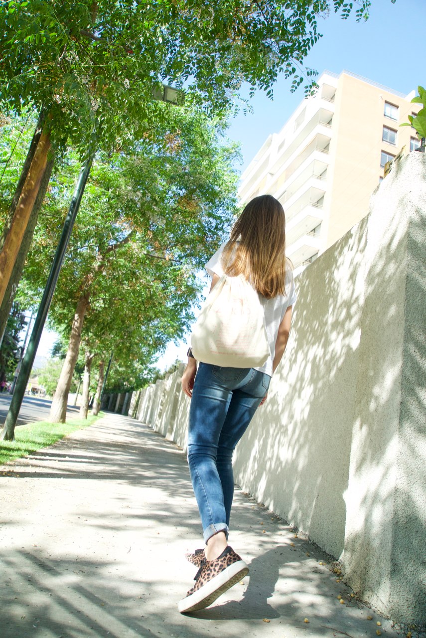 Woman walking away wearing a Zekaio drawstring bag