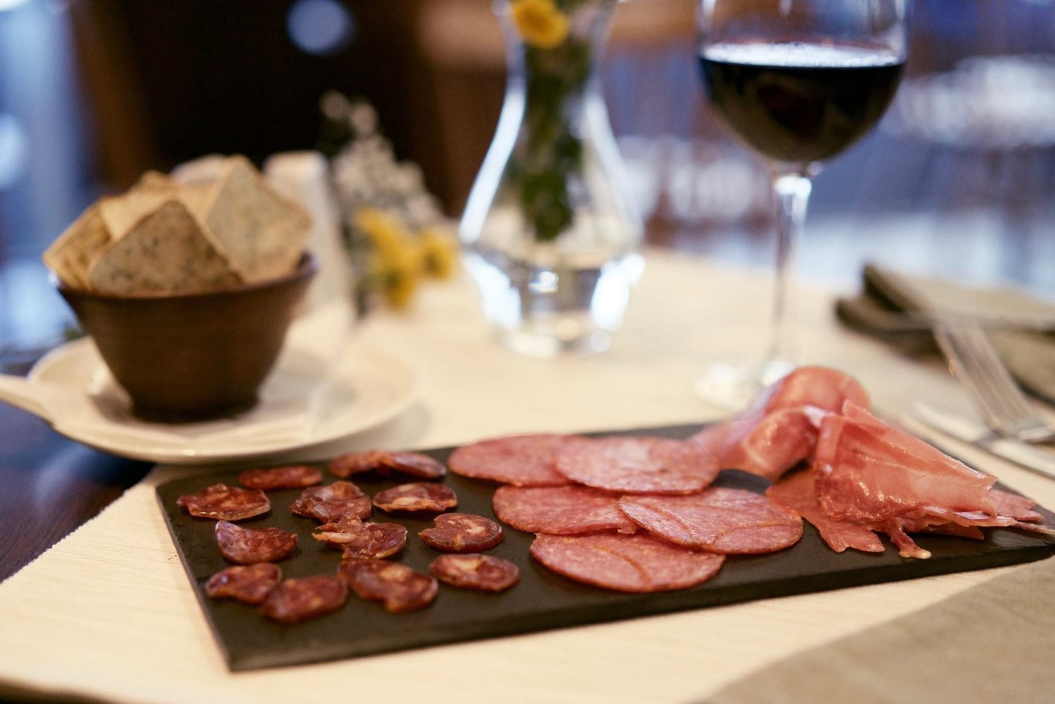 Charcuterie plate with a glass of red wine